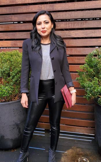 reviewer wearing the black leggings with a blazer and black open-toe boots