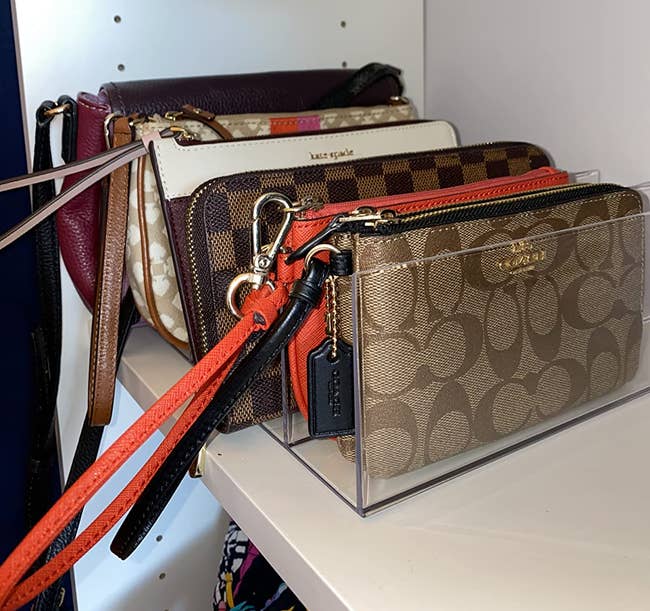 side view of a reviewer's rack holding coach wallets