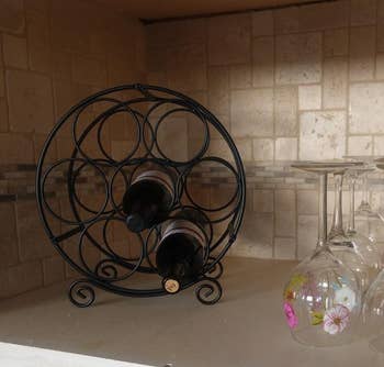 Reviewer image of black wine rack with two bottles