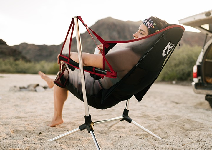 Daily News | Online News model reclining in recliner chair on the beach