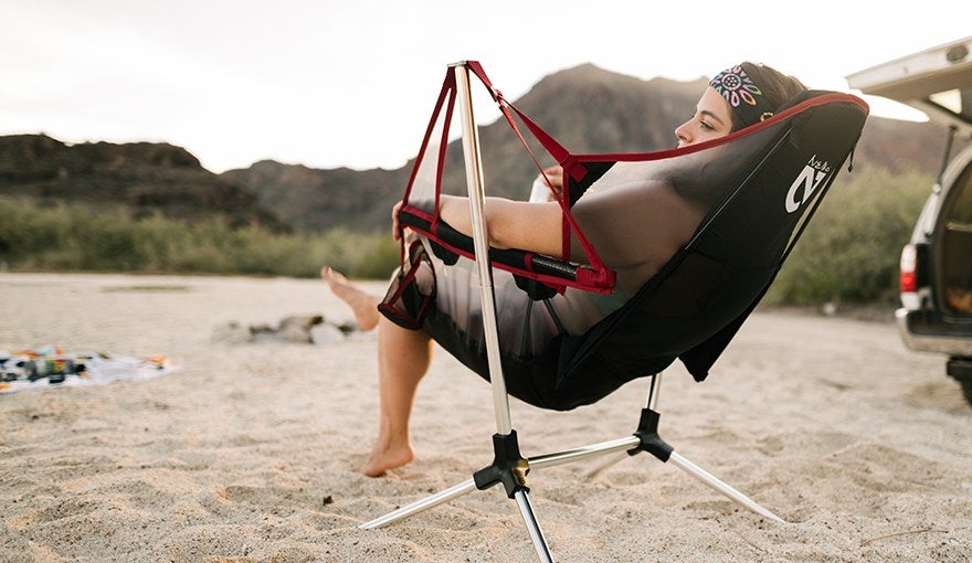 model reclining in recliner chair on the beach