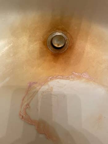 sink in the process of having a rust stain removed with the pink stuff