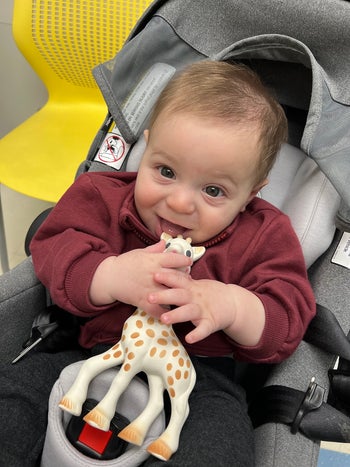 editor's child chewing on sophia the giraffe