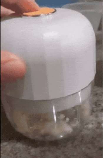 gif of a reviewer using the wireless garlic chopper