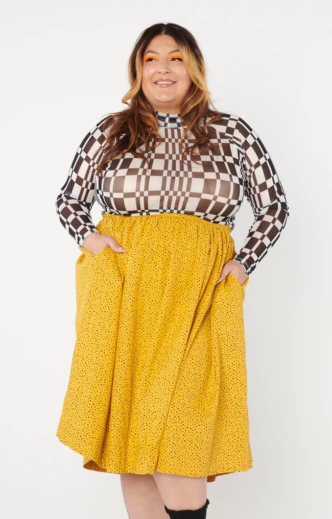 a model wearing the mustard yellow skirt