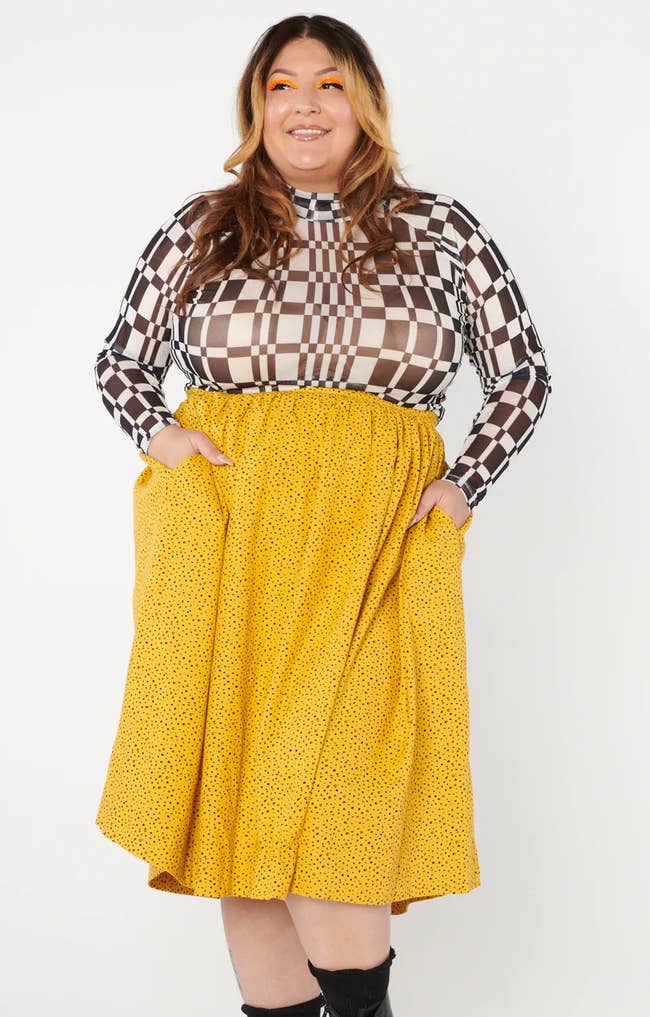 a model wearing the mustard yellow skirt