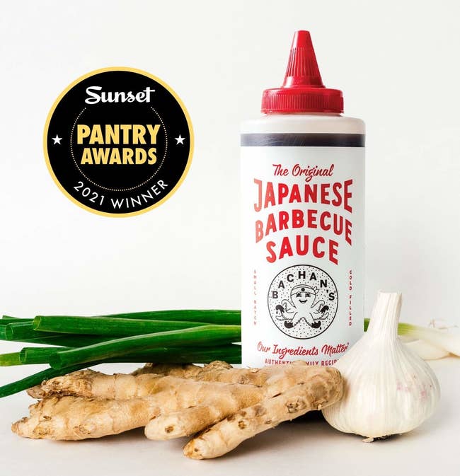 Bottle of Bachan's Japanese Barbecue Sauce with a Sunset Pantry Awards 2021 winner badge, accompanied by fresh ginger and garlic