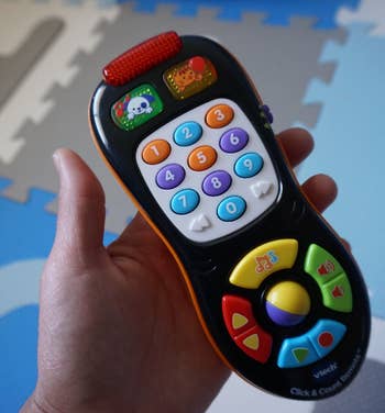 reviewer holding toy remote