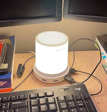 the led touch lamp glowing on a reviewer's work desk