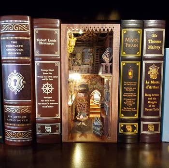 An intricate book nook place between books