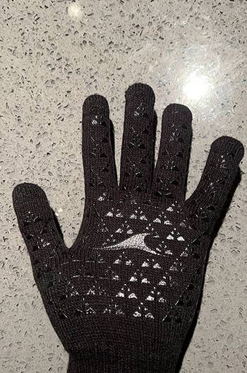Reviewer wearing black thermal glove, palm side up