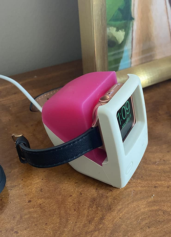 side view of a watch sitting in the stand