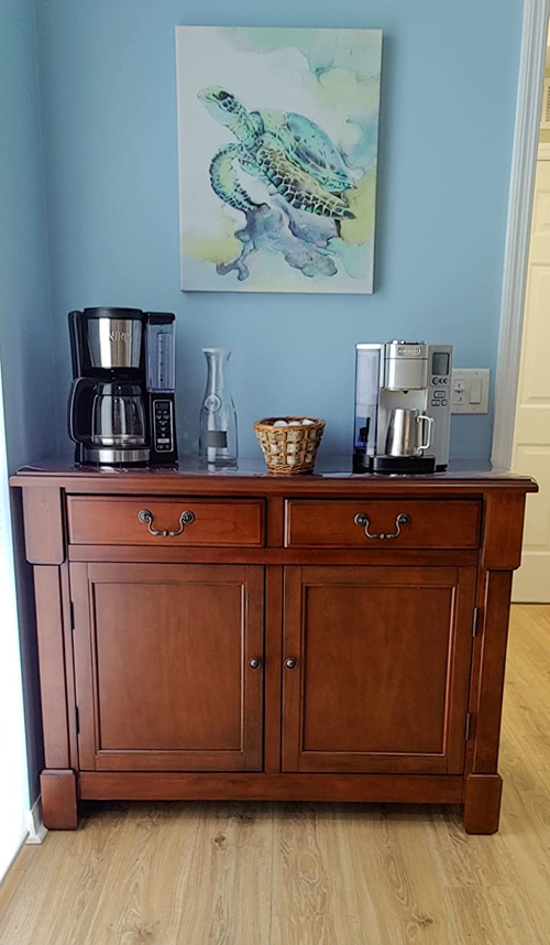 Reviewer image of brown wooden accent cabinet with coffee supplies on top