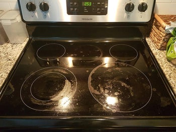 reviewer before image of a dirty glass stovetop