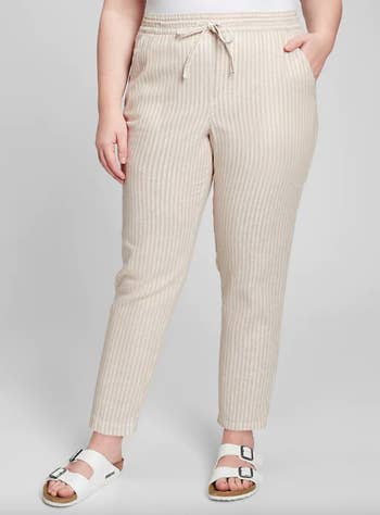 model wearing beige striped linen pants