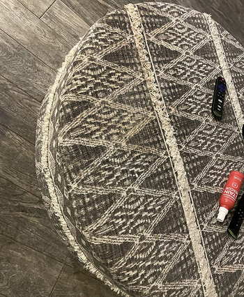 reviewer photo of the same area rug without the stain after being treated with the stain spray
