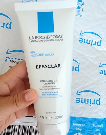Reviewer holding bottle of La Roche-Posay medicated gel cleanser