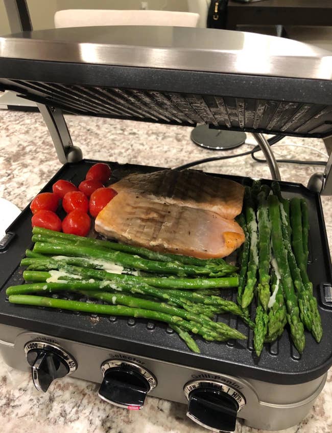 reviewer photo of fish  and veggies being cooked on the griddler