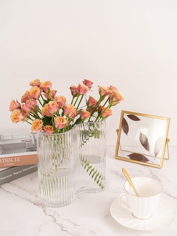 the clear vase holding flowers