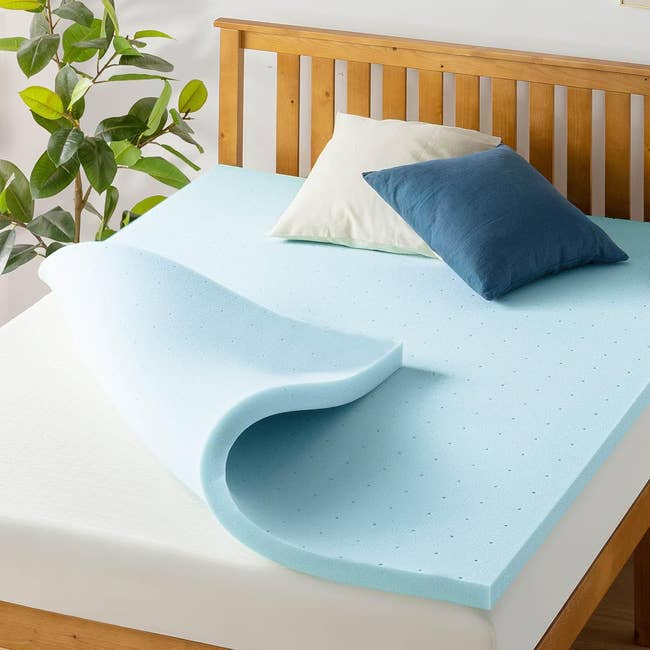Foam mattress topper connected  a bed