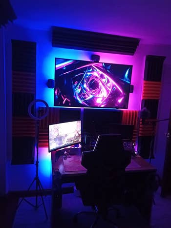 different reviewer's led strips around their desk setup glowing pink and blue