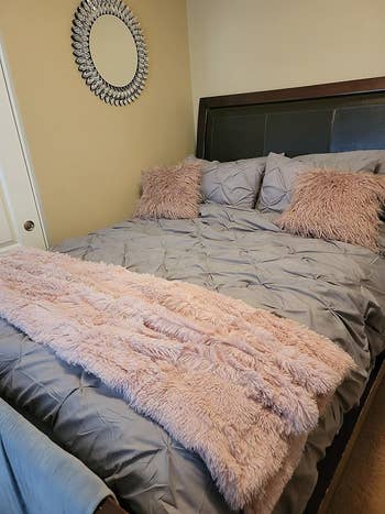 Reviewer's pink blanket on grey bedding