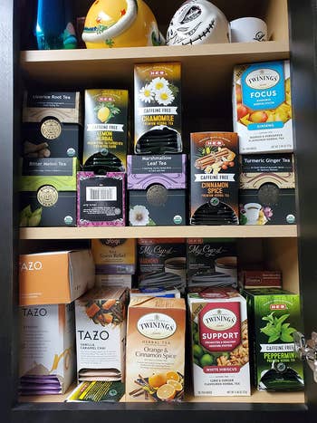 a reviewer's cabinet filled with tea boxes