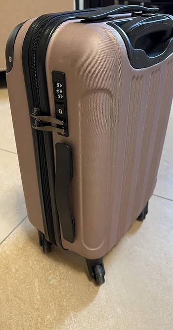 a reviewer photo of the suitcase showing the built-in locking mechanism 