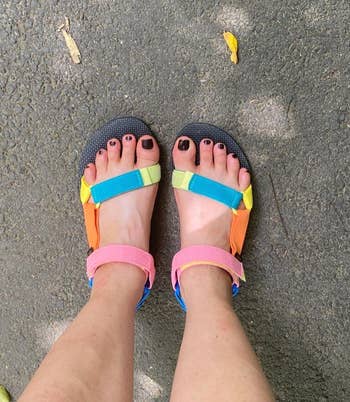 reviewer's feet in the multicolored sandals