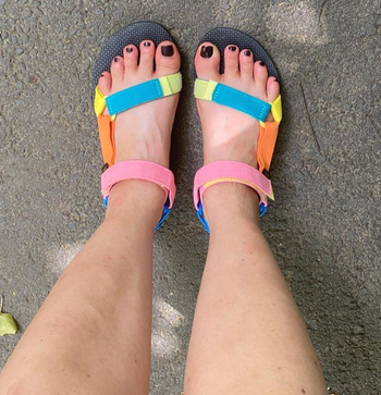reviewer's feet in the multicolored sandals