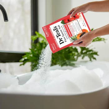 Pouring Dr Teal's Epsom brackish into a bubble bath; the bundle is labeled