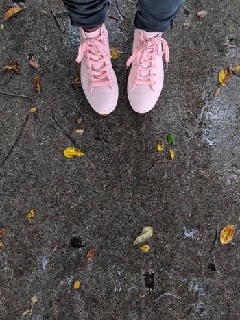 Reviewer wearing pinkish  rainfall  sneakers