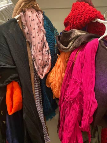 scarves in a jumble on two regular coat hangers