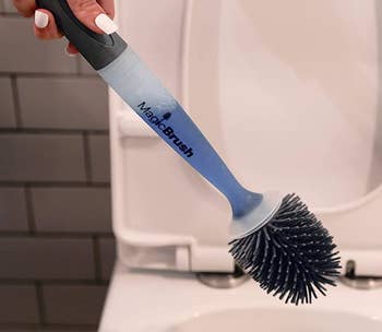 Model using the brush to clean a toilet 