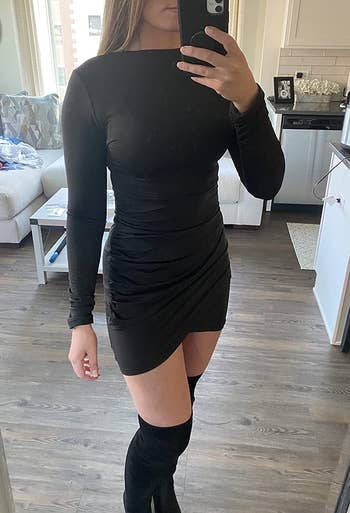 A reviewer wearing the dress in black