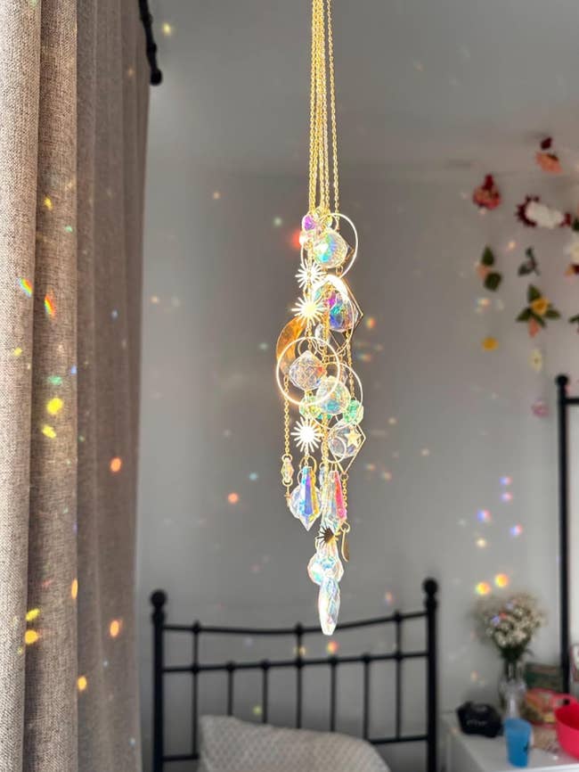Crystal sun catcher hanging with reflective patterns on walls,