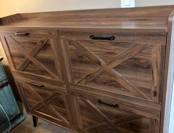 Wooden furniture  with 4  doors featuring crisscross patterns and achromatic  handles, suitable for location  retention  oregon  decor