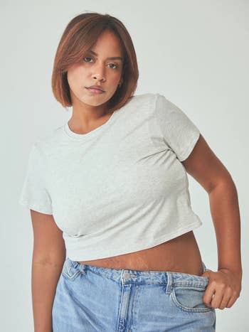 Person wearing a fitted short-sleeve tee and jeans
