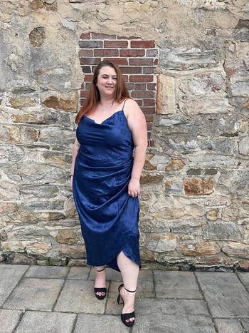 reviewer wearing the dress in blue floral