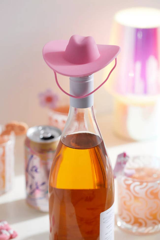 Bottle of rosé with a pink cowboy hat on the top 
