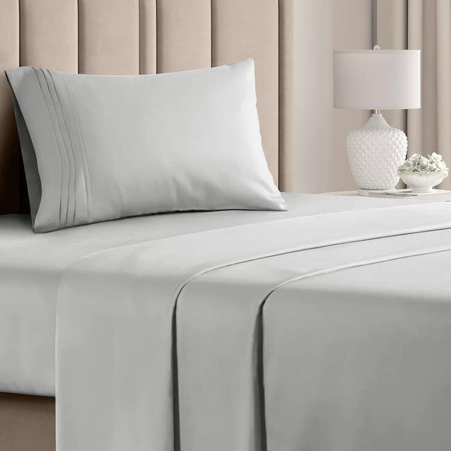 gray bed sheets on a bed with matching pillow