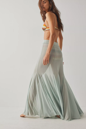 model wearing the mint-colored skirt over a bikini