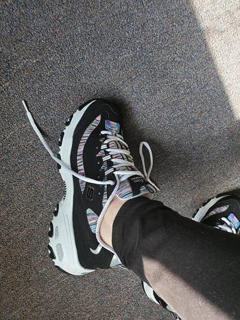 Reviewer wearing Skechers DLite sneakers
