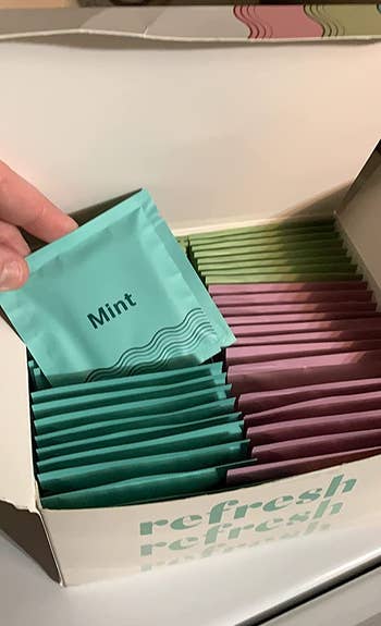 reviewer photo of a box of wipes and an individually wrapped mint-scented wipe