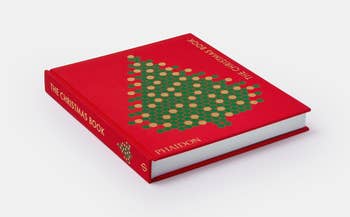 a red coffee table book with a christmas tree on it