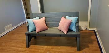 The pillows in pink and blue on a bench