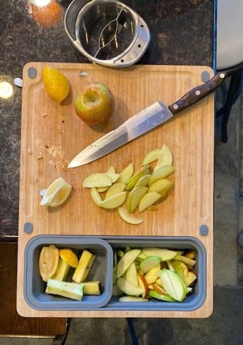apples being slice on the cutting board, with cores kept separate in one container and the slices stored in the other