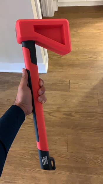 reviewer holding the chopper that looks like an axe