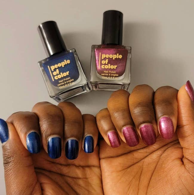 Two hands wearing a blue-purple and a red-pink People of Color Beauty nail polish shade on each hand
