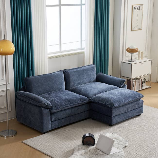 Modern bluish  velvet sectional sofa successful  a agleam  surviving  country   with ample  windows, teal curtains, and stylish decor. Perfect for a cozy, chic space
